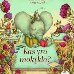 drambliukas sėdi prie stalo ir skaito knygą